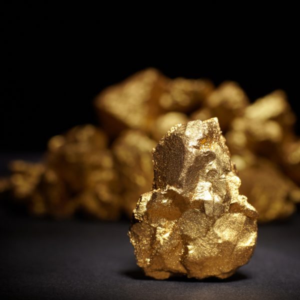 Closeup of big gold nugget on a black background